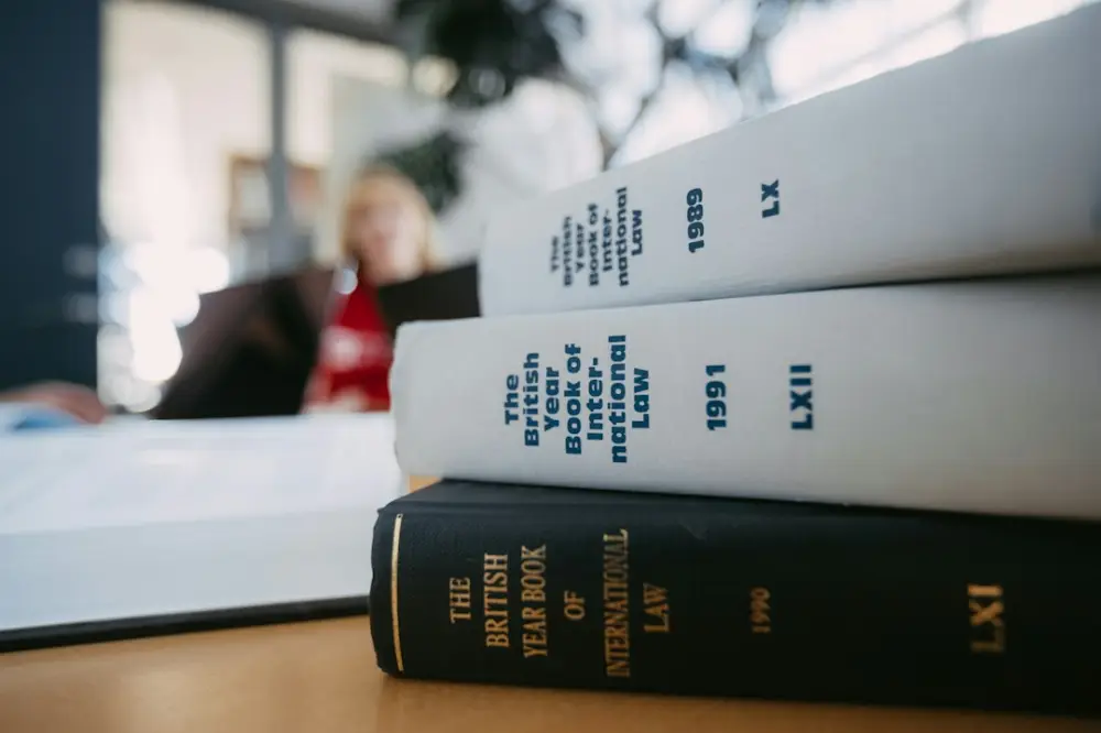 Legal books are stacked on a desk